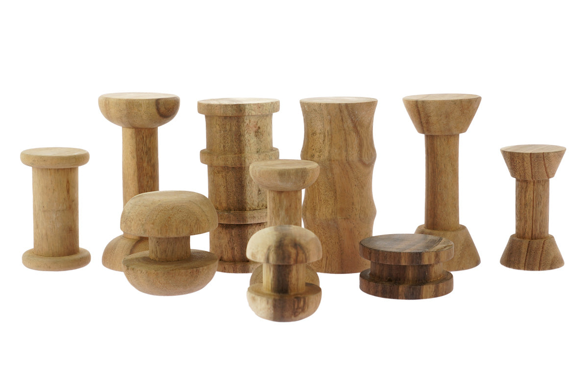 Papoose childrens stacking wooden spool toy blocks lined up on a white background