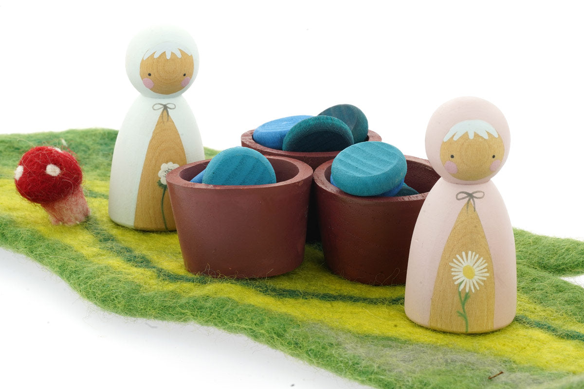 Papoose wooden bowls filled with Grapat wooden counters next to some Peepul wooden peg dolls