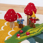 The Papoose Toys Toadstool Garden set up on a rug. 