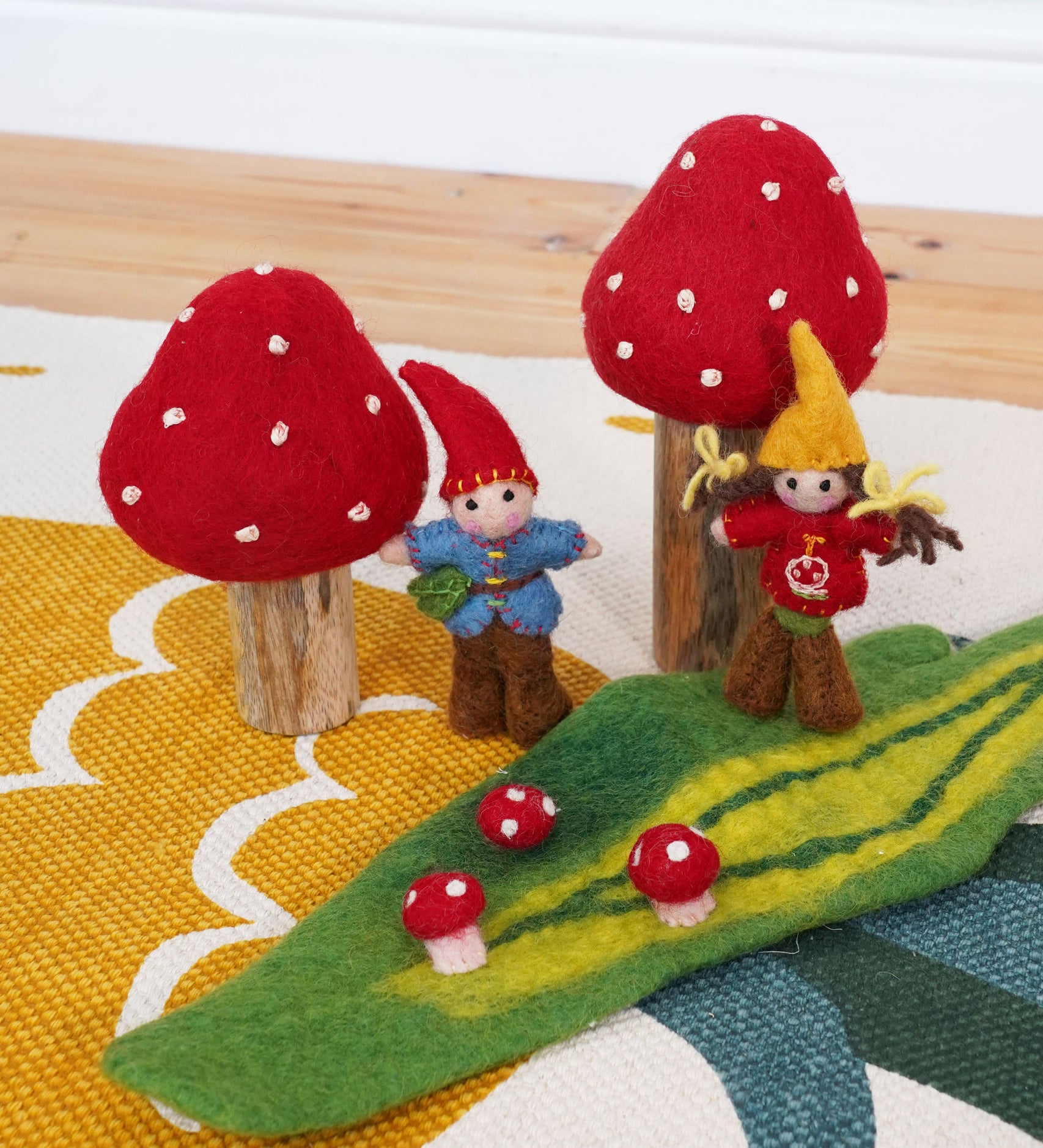 The Papoose Toys Toadstool Garden set up on a rug. 