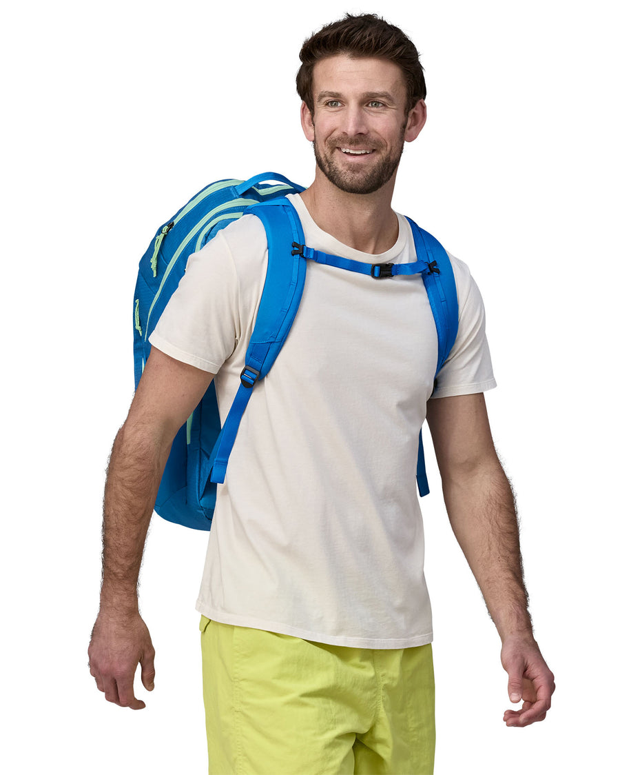 A person wearing the Patagonia Black Hole Recycled Backpack 32L - Vessel Blue