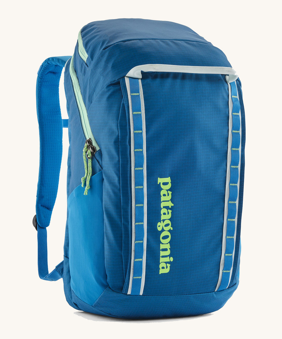 Patagonia Black Hole Recycled Backpack 32L - Vessel Blue. An ocean blue backpack with light green lettering and details, on a cream background