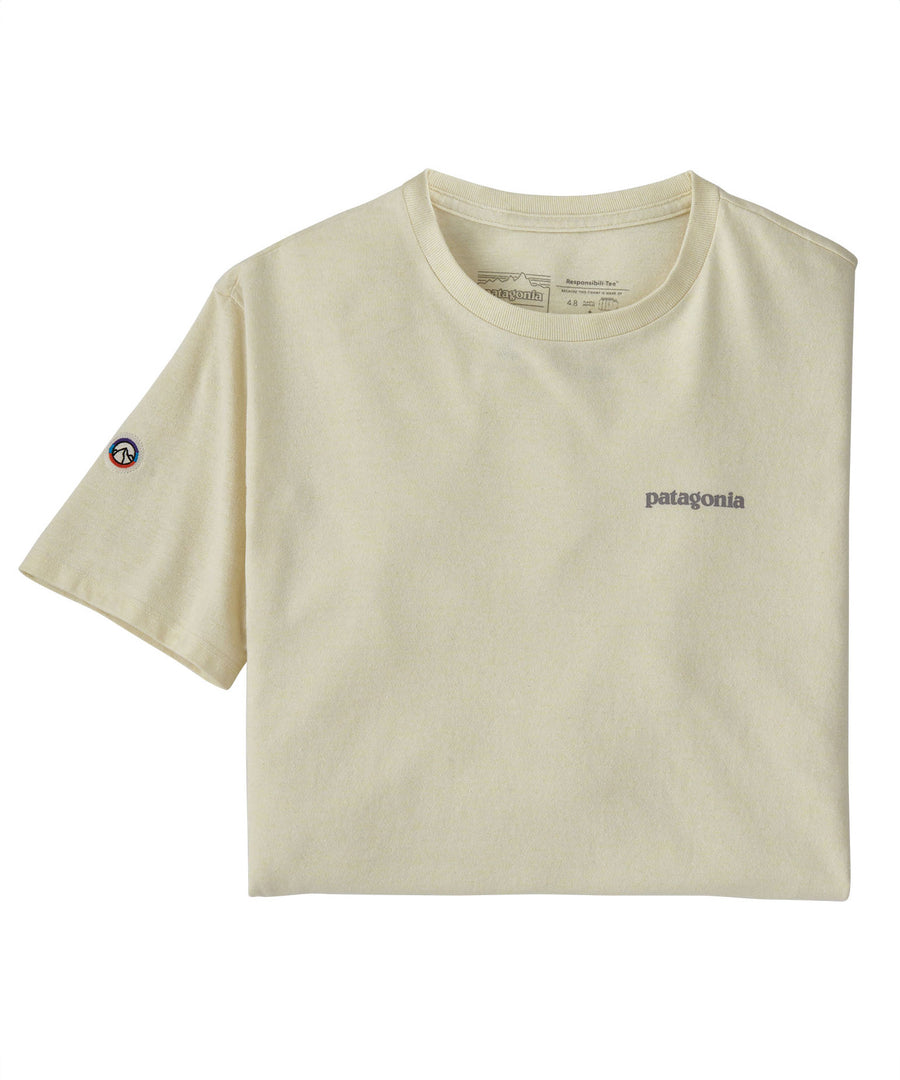 The Patagonia Adult Fitz Roy Icon Responsibili-Tee in a Birch White colour folded into a square with one sleeve out. The grey coloured patagonia logo can be seen on the top right of the top. A small round mountain badge detail can be seen on the left sleeve.