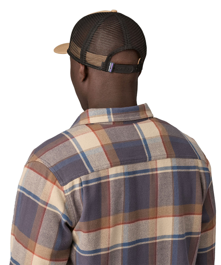 A man wearing a Patagonia Adult P-6 Logo Trucker Hat Grayling Brown