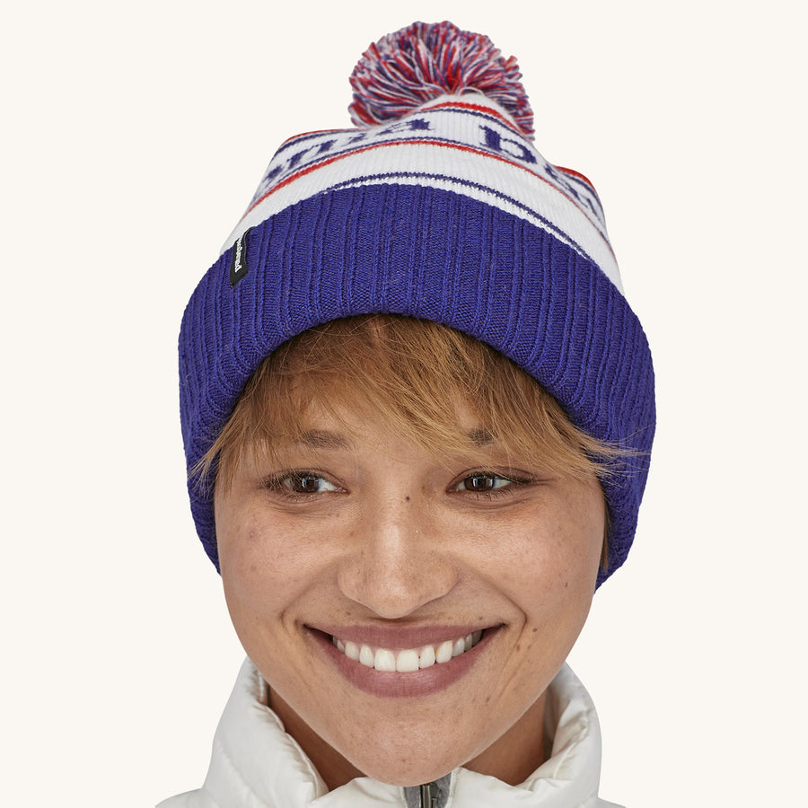 Patagonia Powder Town Beanie Bobble Hat - Park Stripe / Viking Blue. A woman wears the beanie facing forward against a plain background.