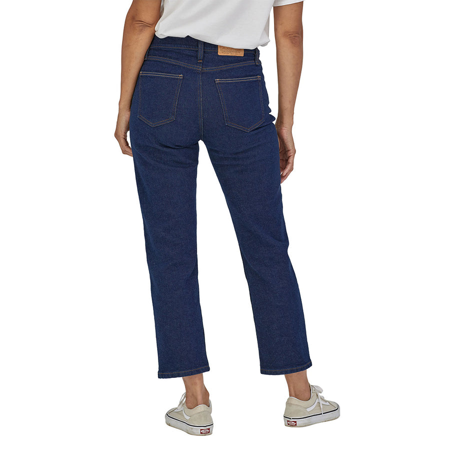 Woman wearing the Patagonia straight navy jeans on a white background