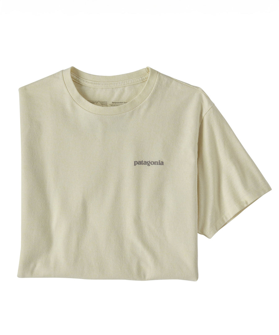 The Patagonia Adult Fitz Roy Icon Responsibili-Tee in a Birch White colour folded into a square with one sleeve out. The grey coloured patagonia logo can be seen on the top left of the top.