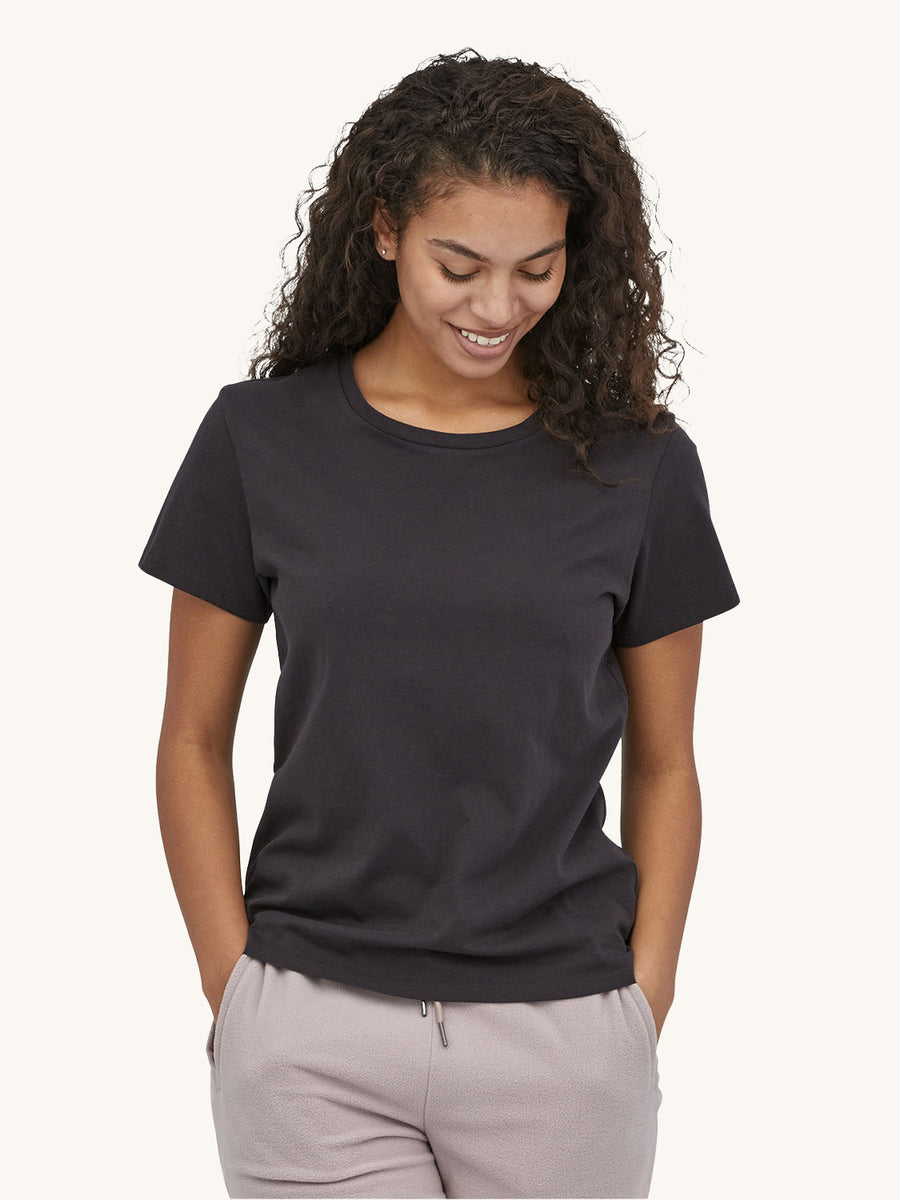 A person wearing the Patagonia Women's Regenerative Organic T-Shirt - Ink Black