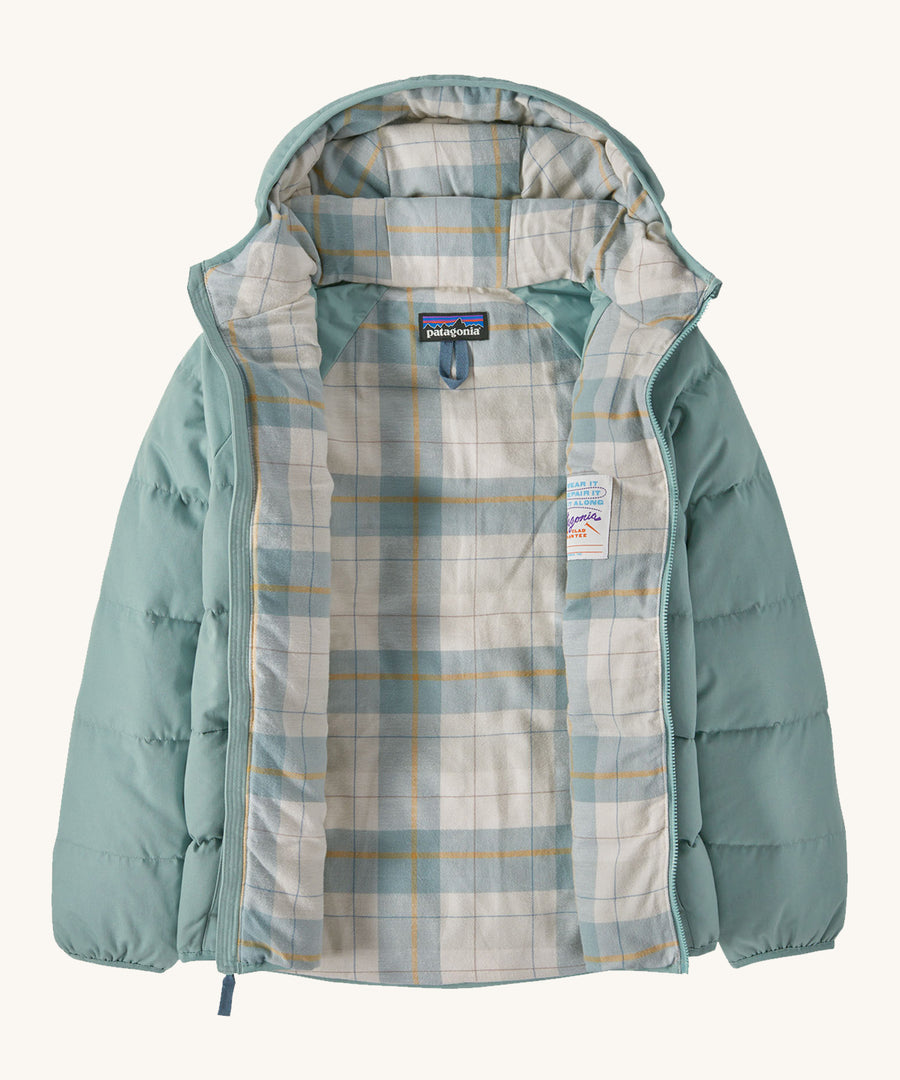 Patagonia Kids Cotton Down Jacket in a Thermal Blue colour on a plain background. The front zip is fully open and the check patterned lining can be seen. 