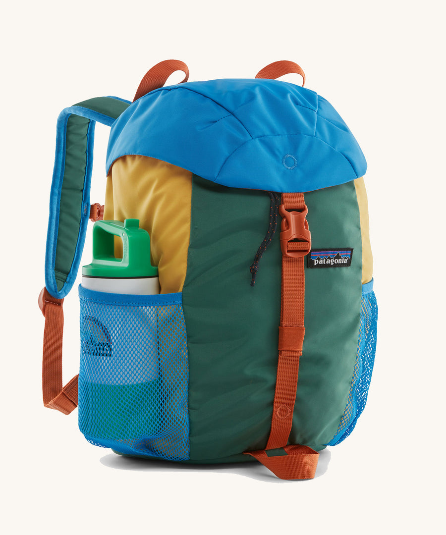 The Patagonia Kids Refugito 12L in a Conifer Green colour way with a water bottle in the side pocket on a plain background.