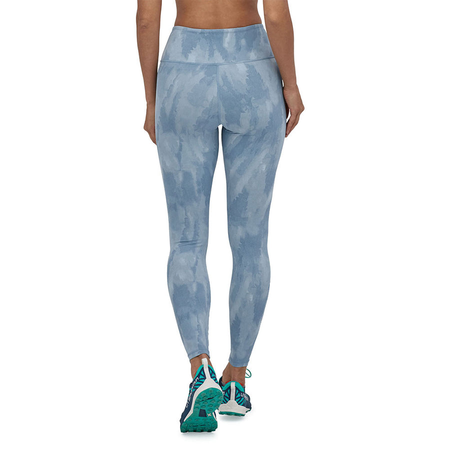 Woman stood backwards on a white background in the light plume grey Patagonia maipo 7/8 performance leggings