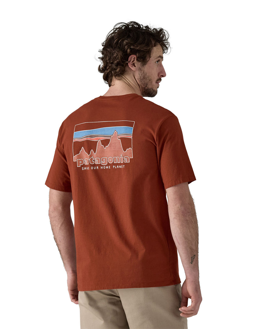 A man waering teh Patagonia Men's 73 Skyline Organic T-Shirt Burnished Red showing the back of the top