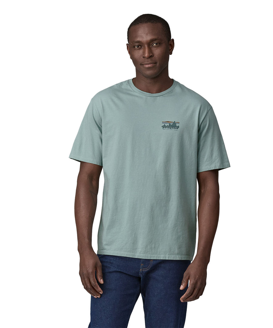 A man wearing the Patagonia Men's 73 Skyline Organic T-Shirt Thermal Blue