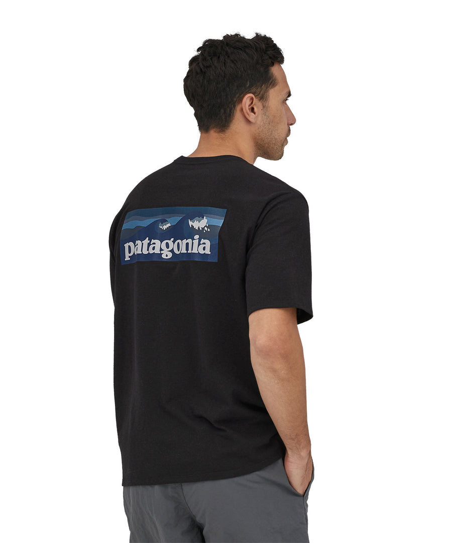 A man wearing a Patagonia Men's Boardshort Logo Pocket Responsibili-Tee Ink Black showing the back 