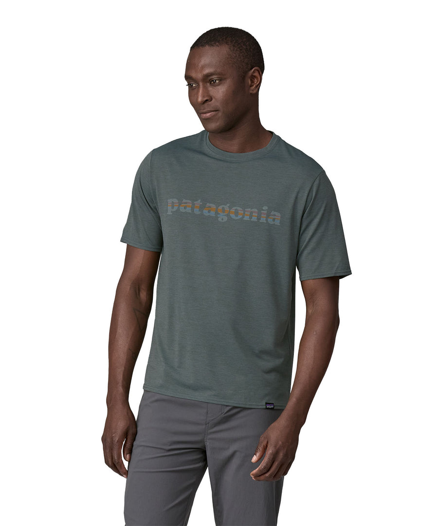 A man wearing a Patagonia Men's Cap Cool Daily Graphic Shirt in Nouveau Green