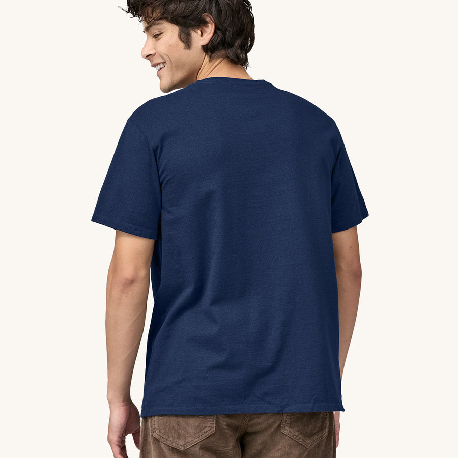 A man models the back of the Patagonia Men's Fitz Roy Icon Responsibili-Tee - Lagom Blue on a plain background.