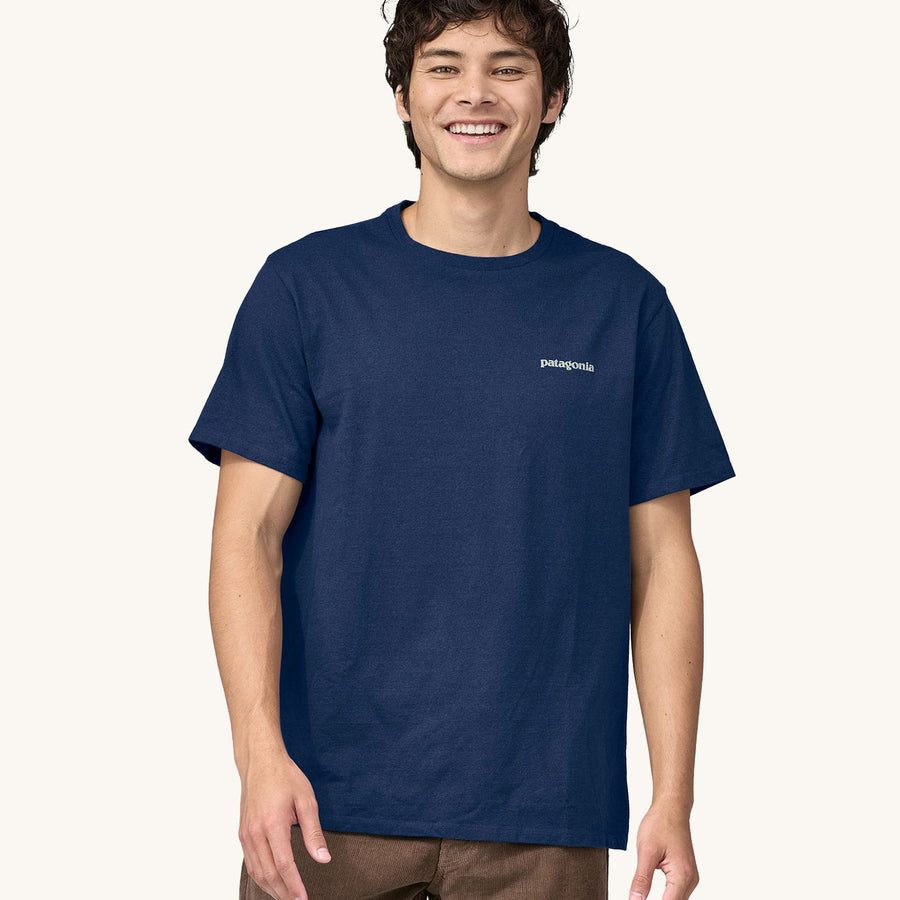 A man models the front of the Patagonia Men's Fitz Roy Icon Responsibili-Tee - Lagom Blue on a plain background.