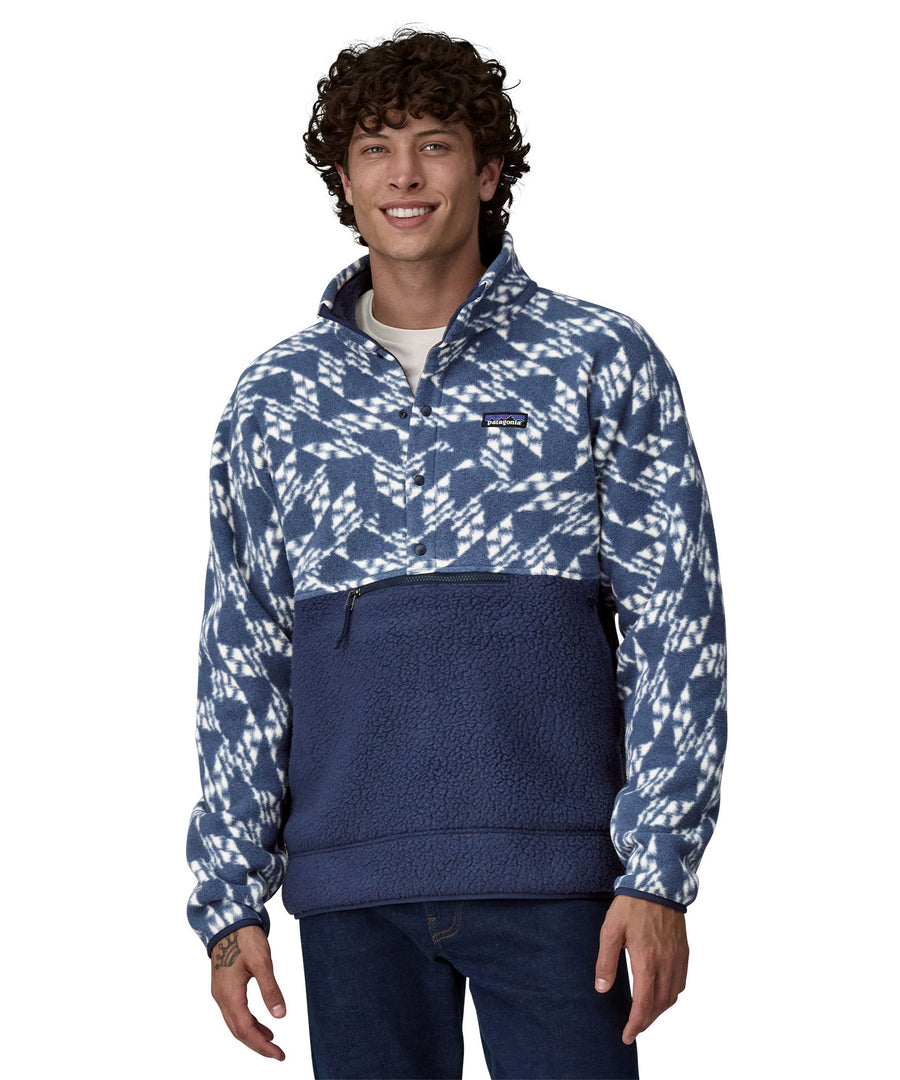 A man wearing a Patagonia Men's Retro Pile 1/2 Snap Pull Over in a New Navy design stood in front of a plain background. 