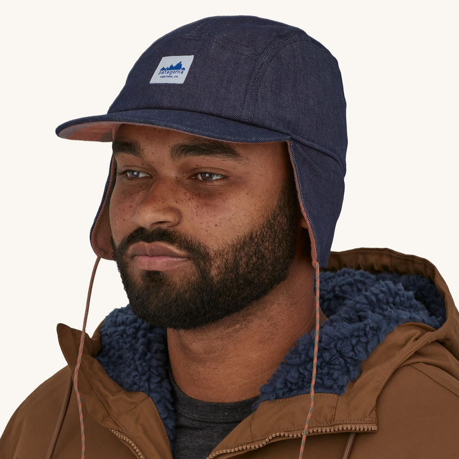 Patagonia Range Earflap Cap - Upriver / Sisu Brown. A man models the side of the cap against a plain background.