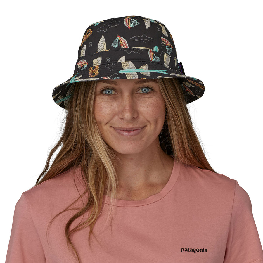 Image of ta person head with long hair wearing the Patagonia Wavefarer Bucket Hat - Fly 50: Ink Black showing the view from the front