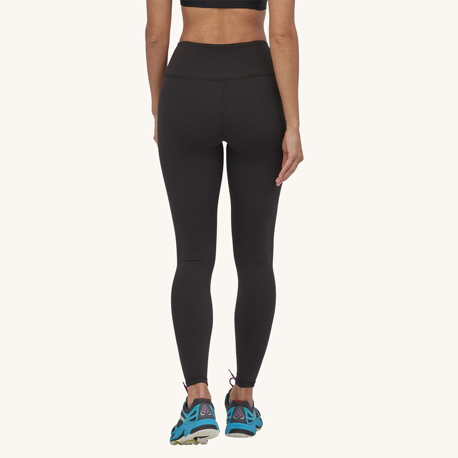 Patagonia Women's Maipo 7/8 Sports Leggings - Black. A woman models the leggings facing away from the camera on a plain background.