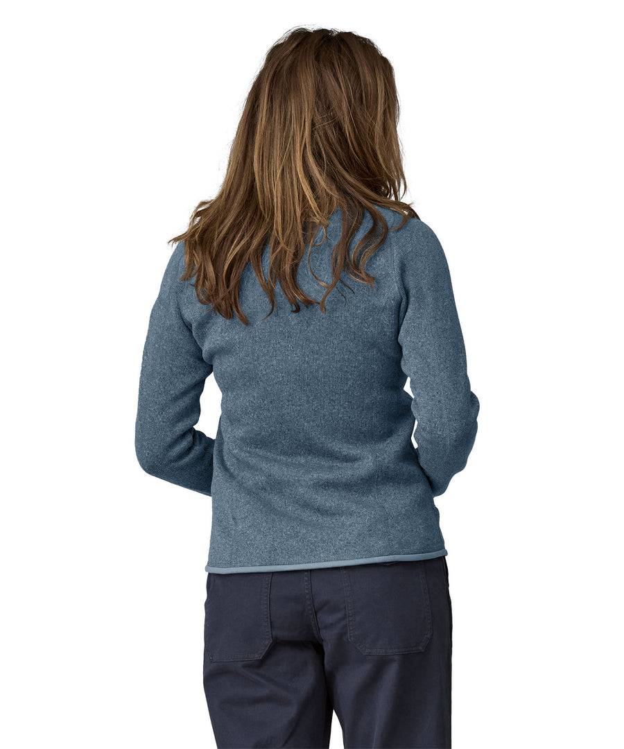 A woman wearing a Patagonia Women's Better Sweater Jacket Utility Blue stood in front of a plain background showing the back of the jacket