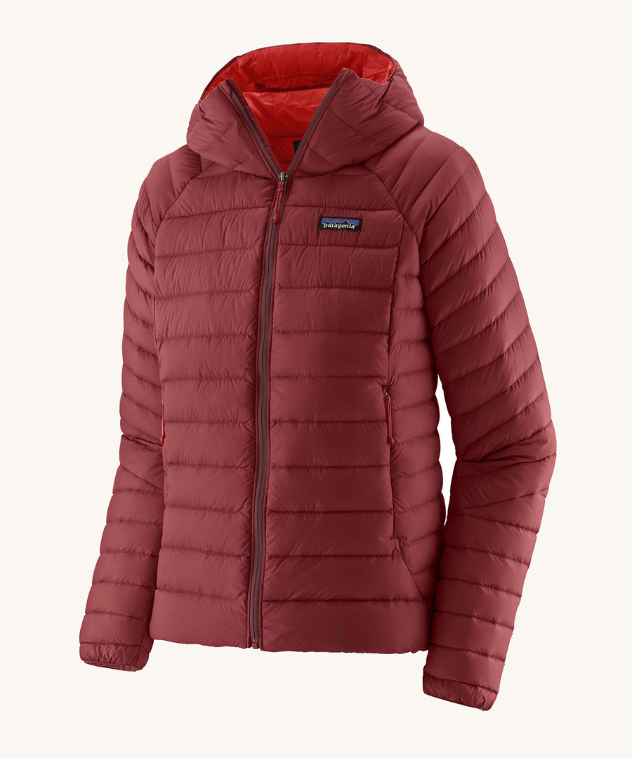 Patagonia Women's Down Sweater Hoody in a Oxide Red colour on a plain bacnground. 