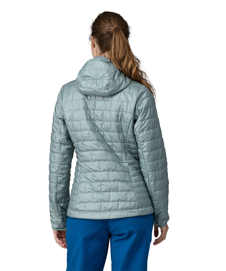 A woman wearing a Patagonia Women's Nano Puff Hoody in Thermal Blue showing the back of the jacket