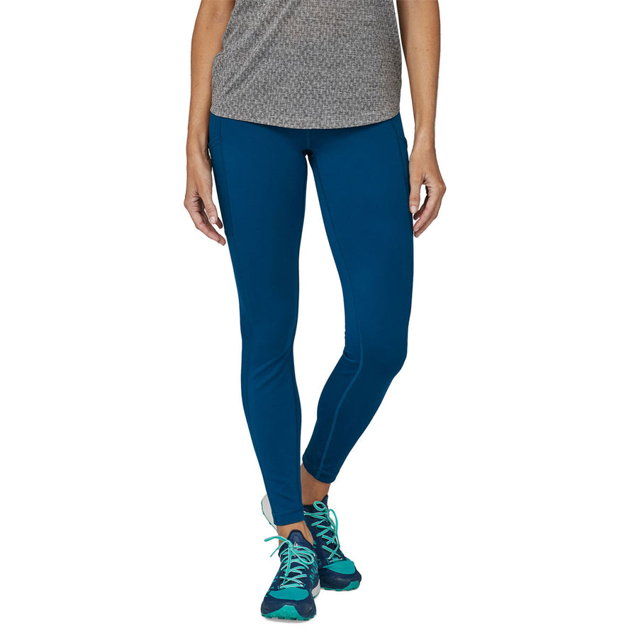 front view of person waering a pair of Patagonia Women's Pack Out Tights  in a blue colourway