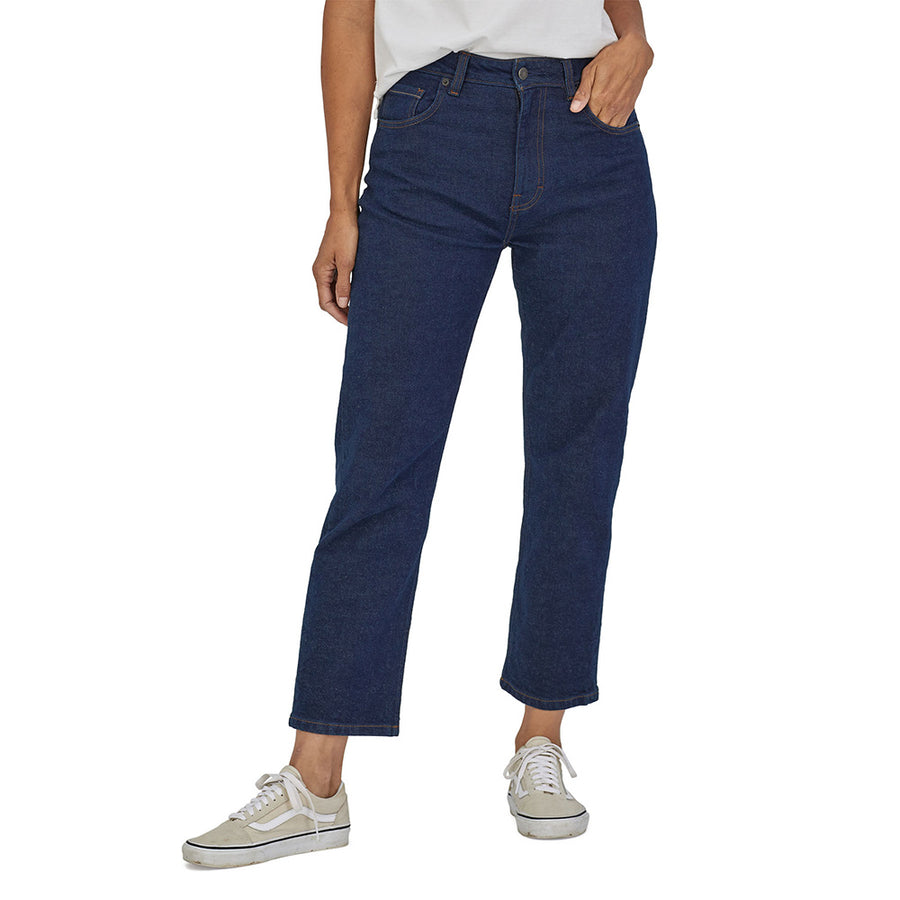 Lady wearing the womens Patagonia straight blue cotton jeans on a white background