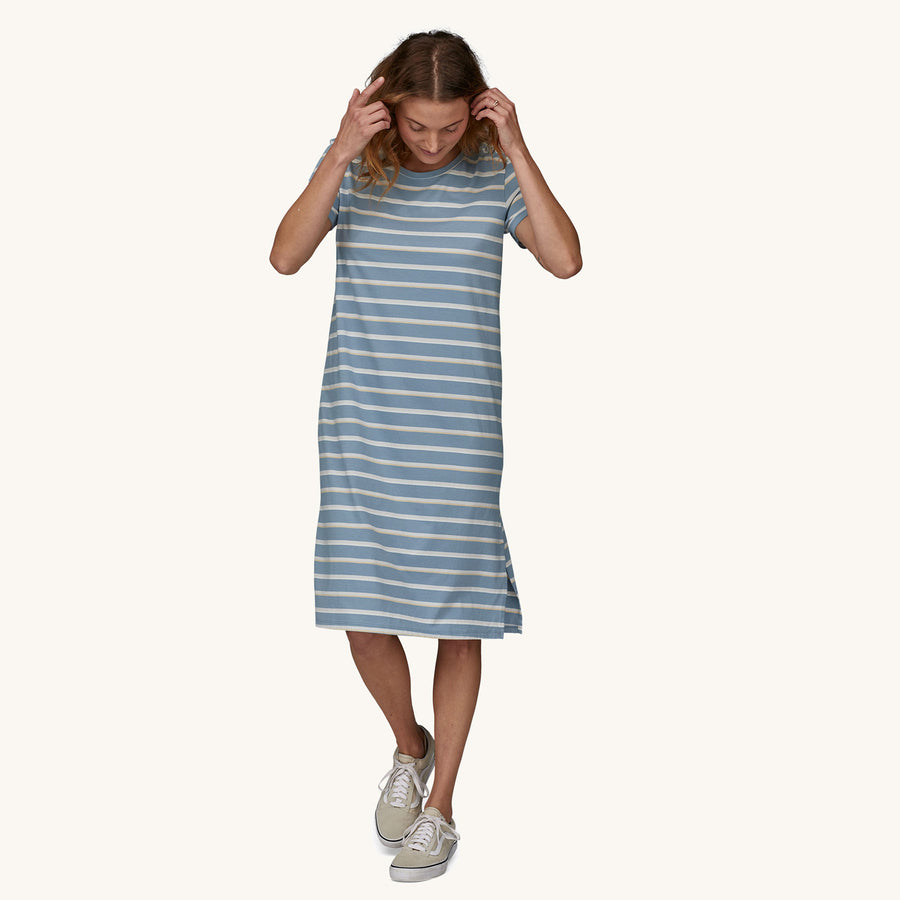 
A person wearing the Patagonia Women's Regenerative T-Shirt Dress - Sunset Stripe/Light Plume Grey showing the front of the dress 
