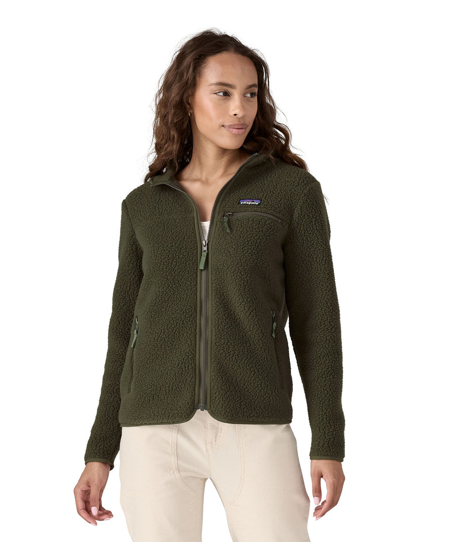 A woman with dark wavy hair wearing a  Patagonia Women's Retro Pile Hoody Pine Needle Green