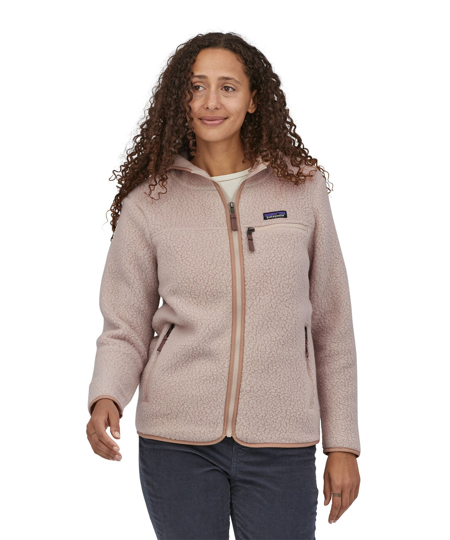 A woman with long curly hair wearing a  Patagonia Women's Retro Pile Hoody Shroom Taupe