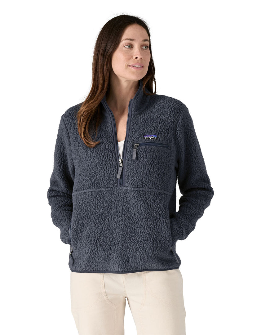 A woman with dark long hair wearing a Patagonia Women's Retro Pile Marsupial jacket in a grey colour