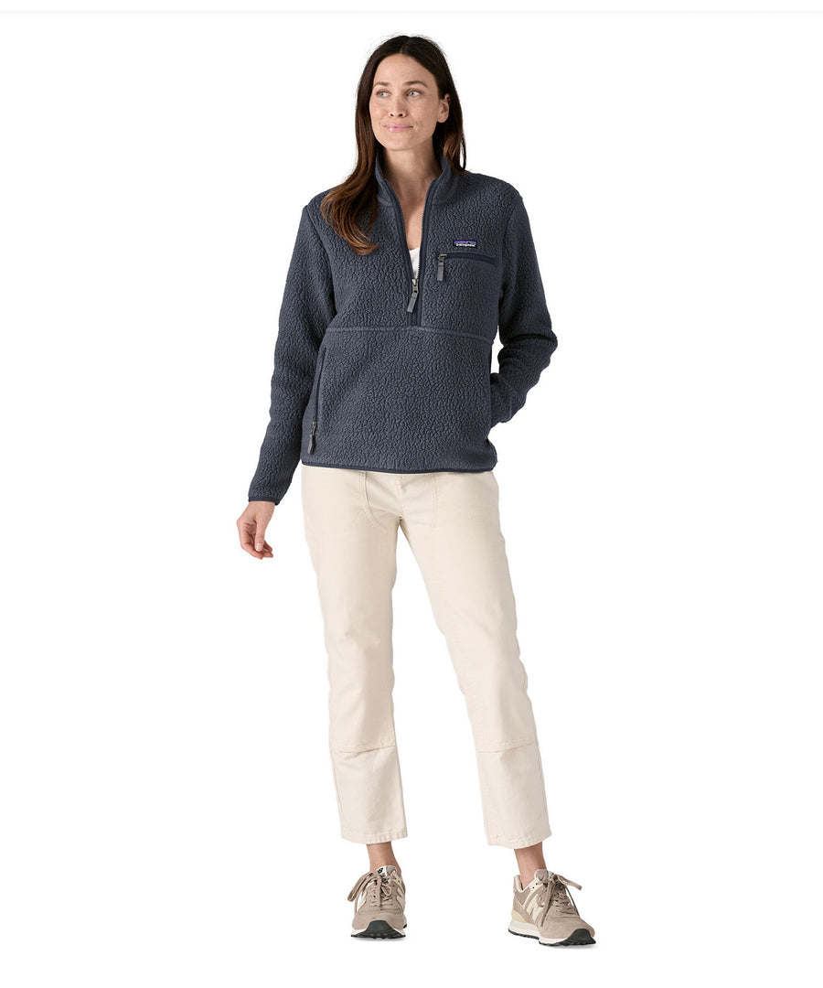 A woman with dark long hair wearing a Patagonia Women's Retro Pile Marsupial jacket in a grey colour