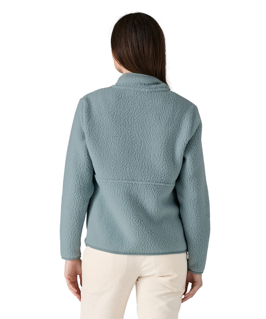 A woman with long dark hair wearing the Patagonia Women's Retro Pile Marsupial Thermal Blue  showing the back of the jacket 