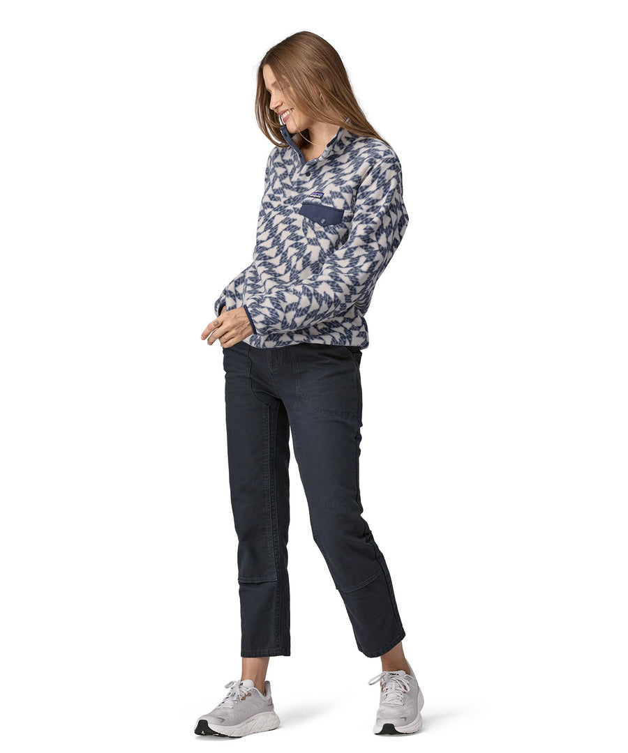 A woman wearing a Patagonia Women's Synch Snap-T pull over Synched Flight Small