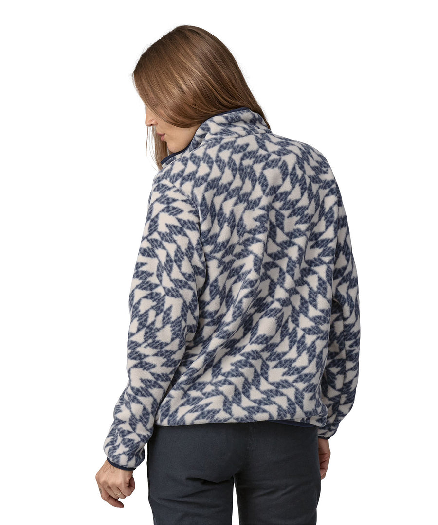 A woman wearing a Patagonia Women's Synch Snap-T pull over Synched Flight Small, showing the back of the jacket