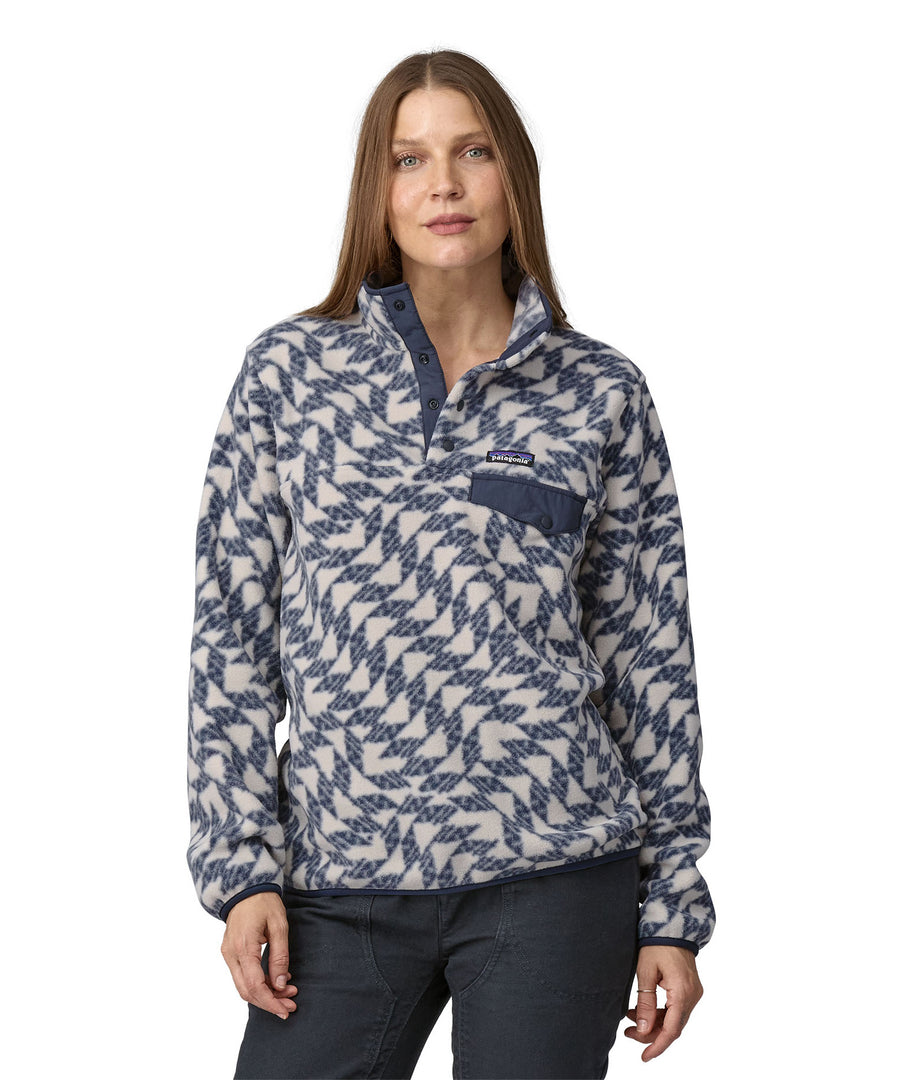 A woman wearing a Patagonia Women's Synch Snap-T pull over Synched Flight Small