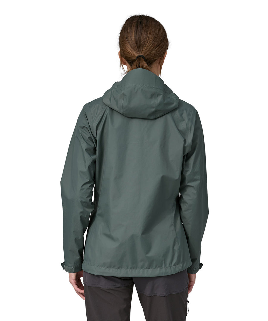 A woman wearing a Patagonia Women's Torrentshell 3L Rain jacket in a Nouveau Green showing the back