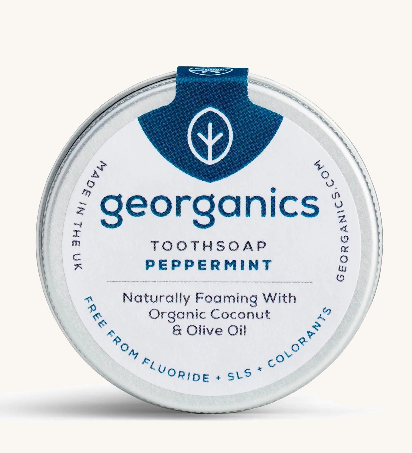 A tin of the peppermint Georganics toothsoap on a cream background