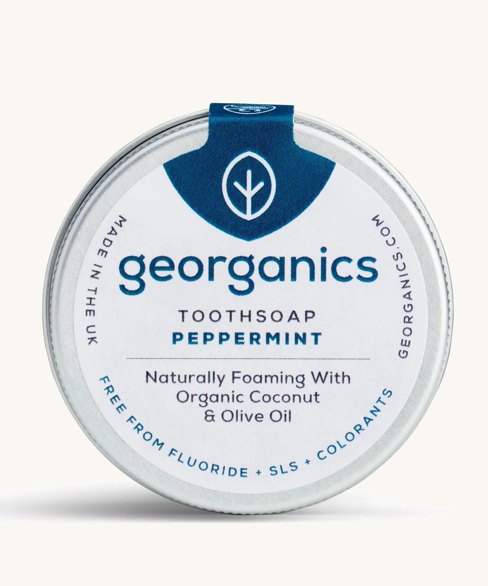 A tin of the peppermint Georganics toothsoap on a cream background