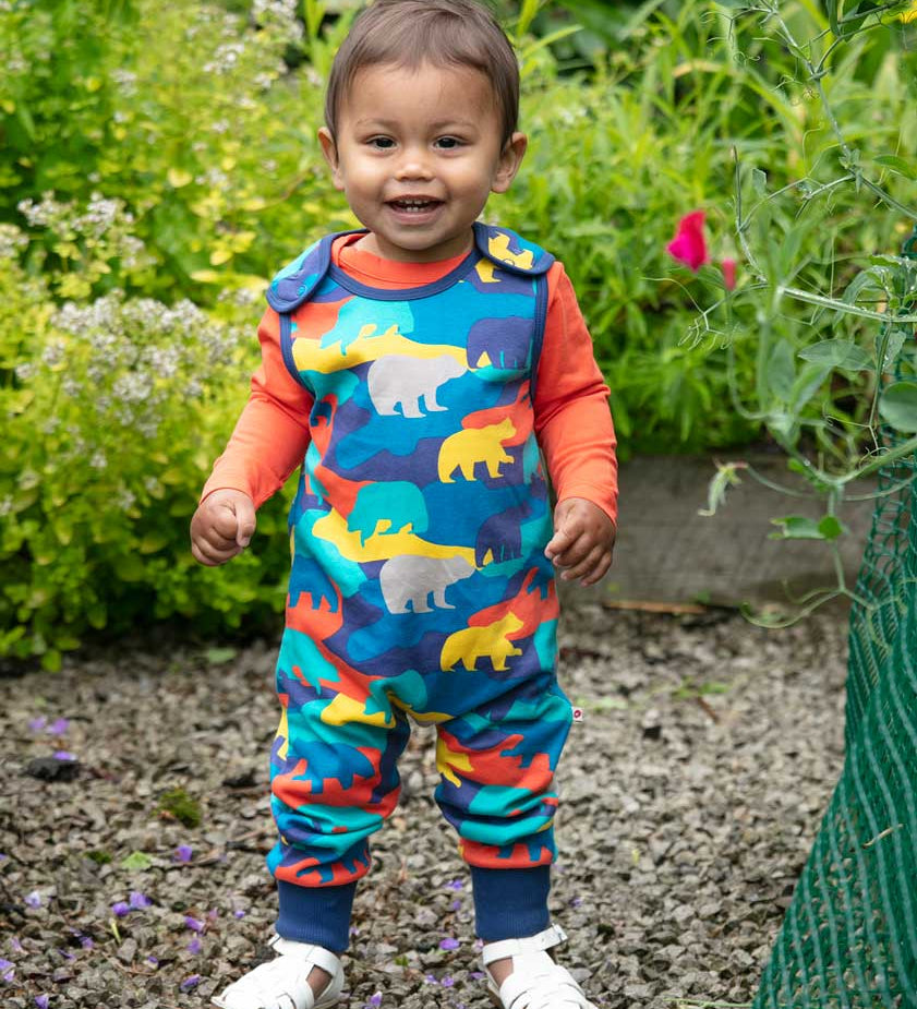 Piccalilly Camo Bear Dungarees being worn by child outdoors