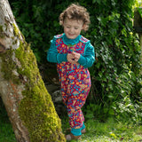 Piccalilly Honey Bear Dungarees being worn by a child outdoors