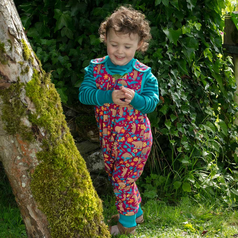 Piccalilly Honey Bear Dungarees being worn by a child outdoors