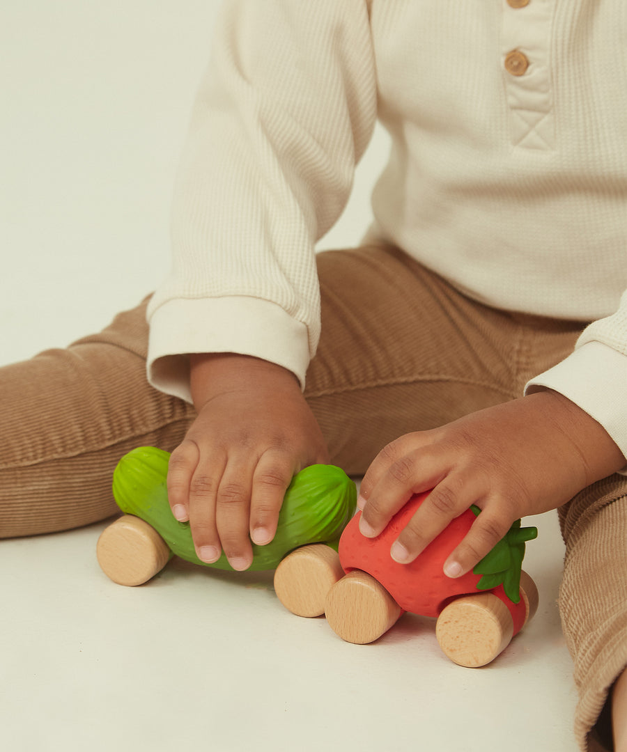 A child playing with the Pickle and Strawberry Oli & Carol Car