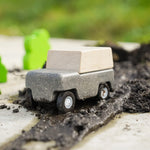 Close up of Plan Toys Wagon in a pile of mud