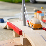 Close up of Plan Toys car on top of the Plan Toys Wooden road set