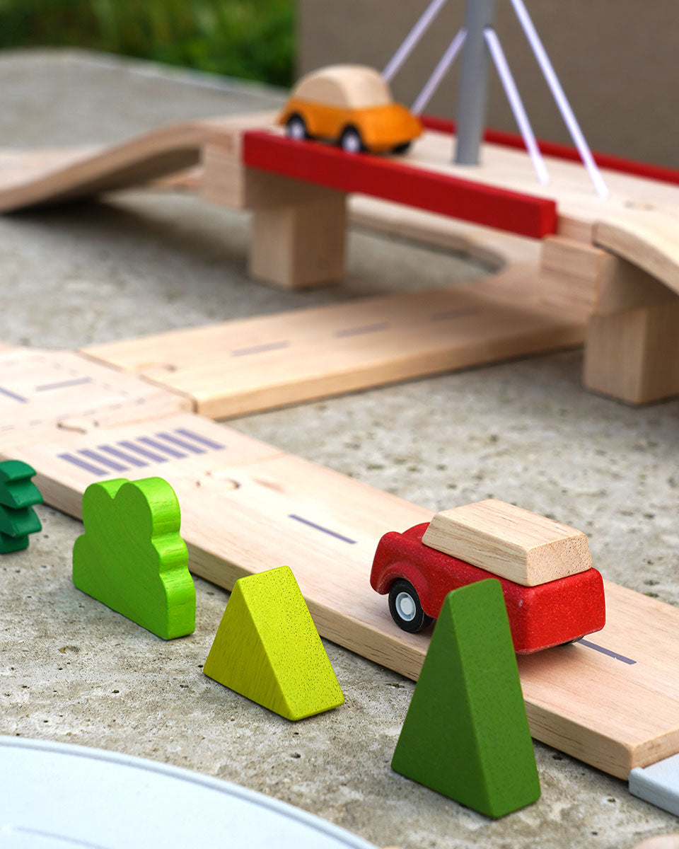 Road going under bridge on the Plan Toys wooden road playset