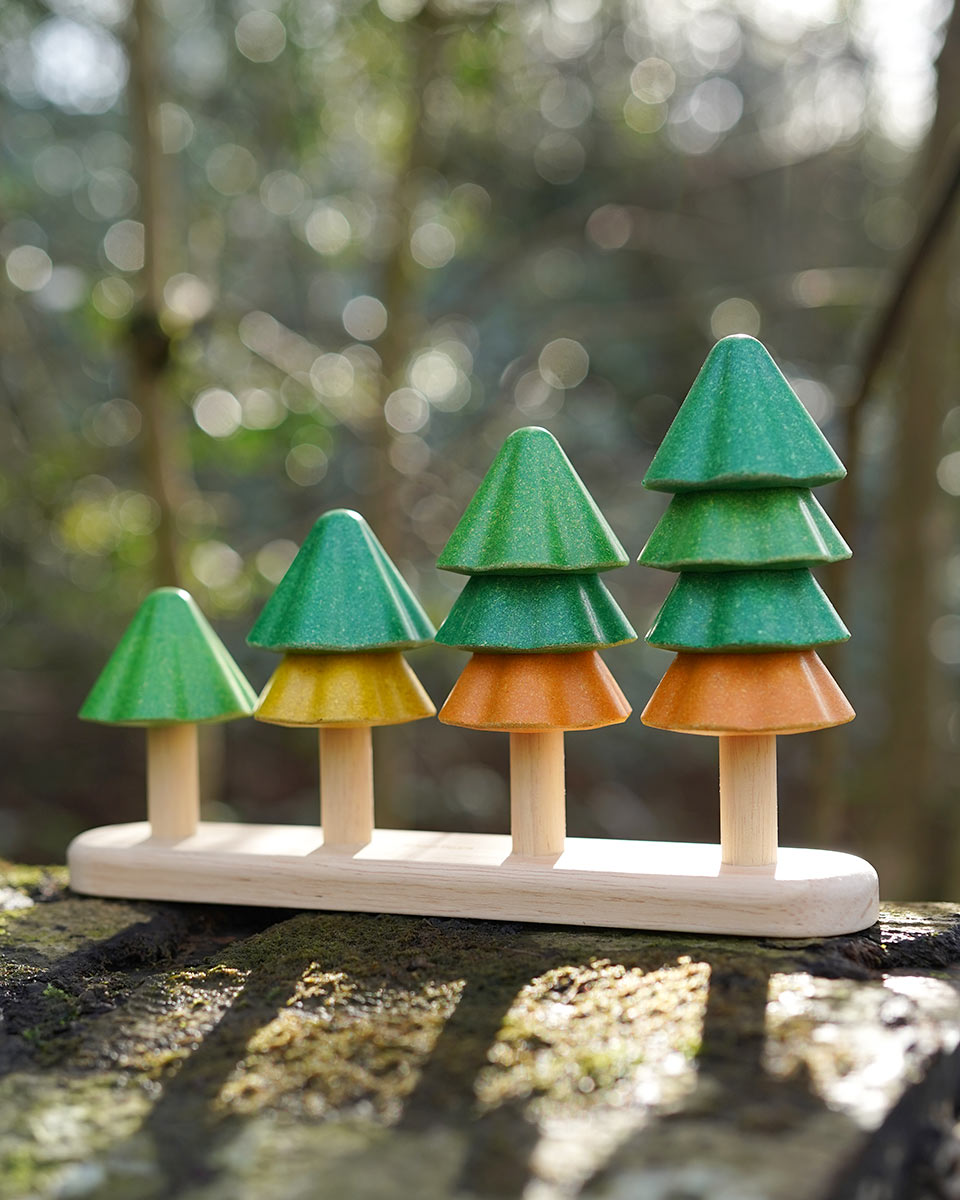 Close up of Plan Toys sustainable Sort and Count Tree toy on a wooden log